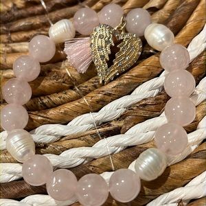 3/$18 NWOT Pink Tassel Bracelet with a Wing Charm Next to the Tassel - Lot 380